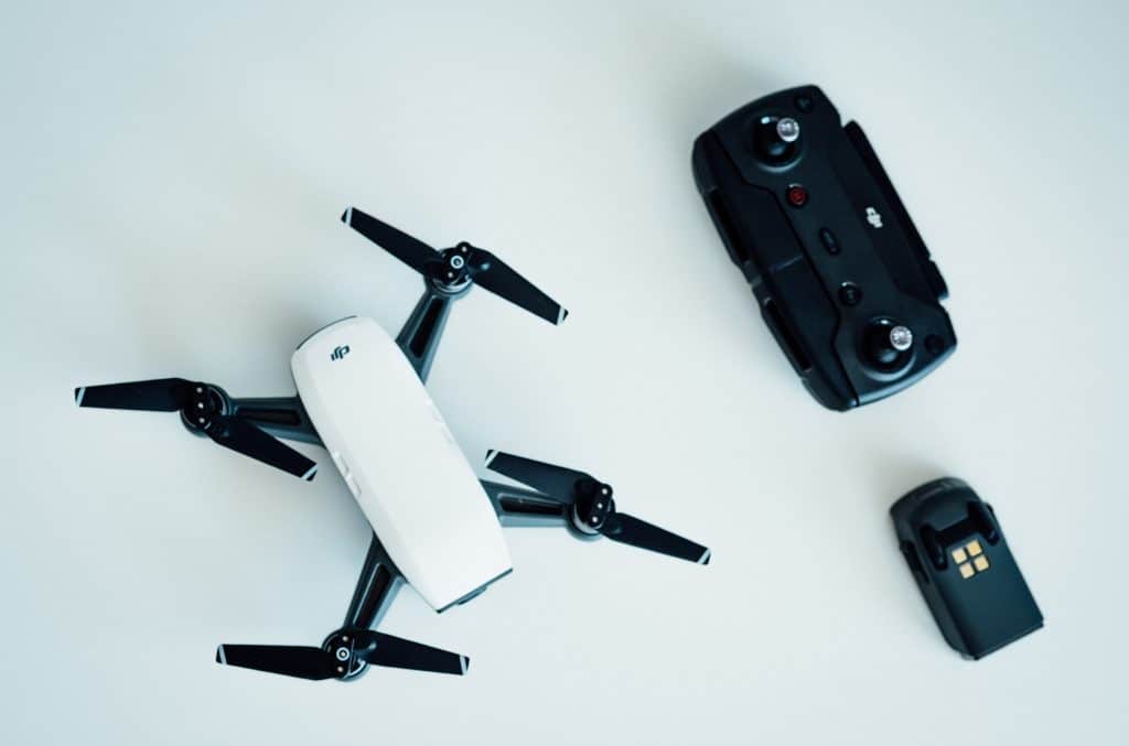 white and black quadcopter drone on white table